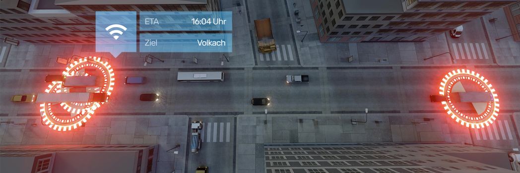 Eine Straßenkreuzung mit verschiedenen Fahrzeugen aus der Vogelperspektive betrachtet. Darauf finden sich GPS Symbole und eine Mitteilung über das ETA.