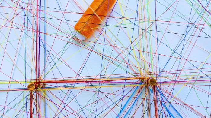 Many colorful threads, which stand for the connections within a logistics chain.