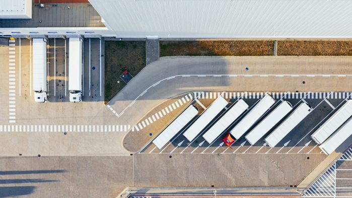 Trucks are parked in the yard of a forwarding company waiting to be loaded and unloaded