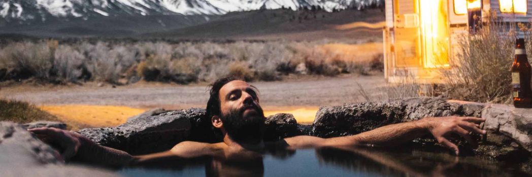 Employee relaxes in a pool on vacation, not having to worry about anything thanks to managed services