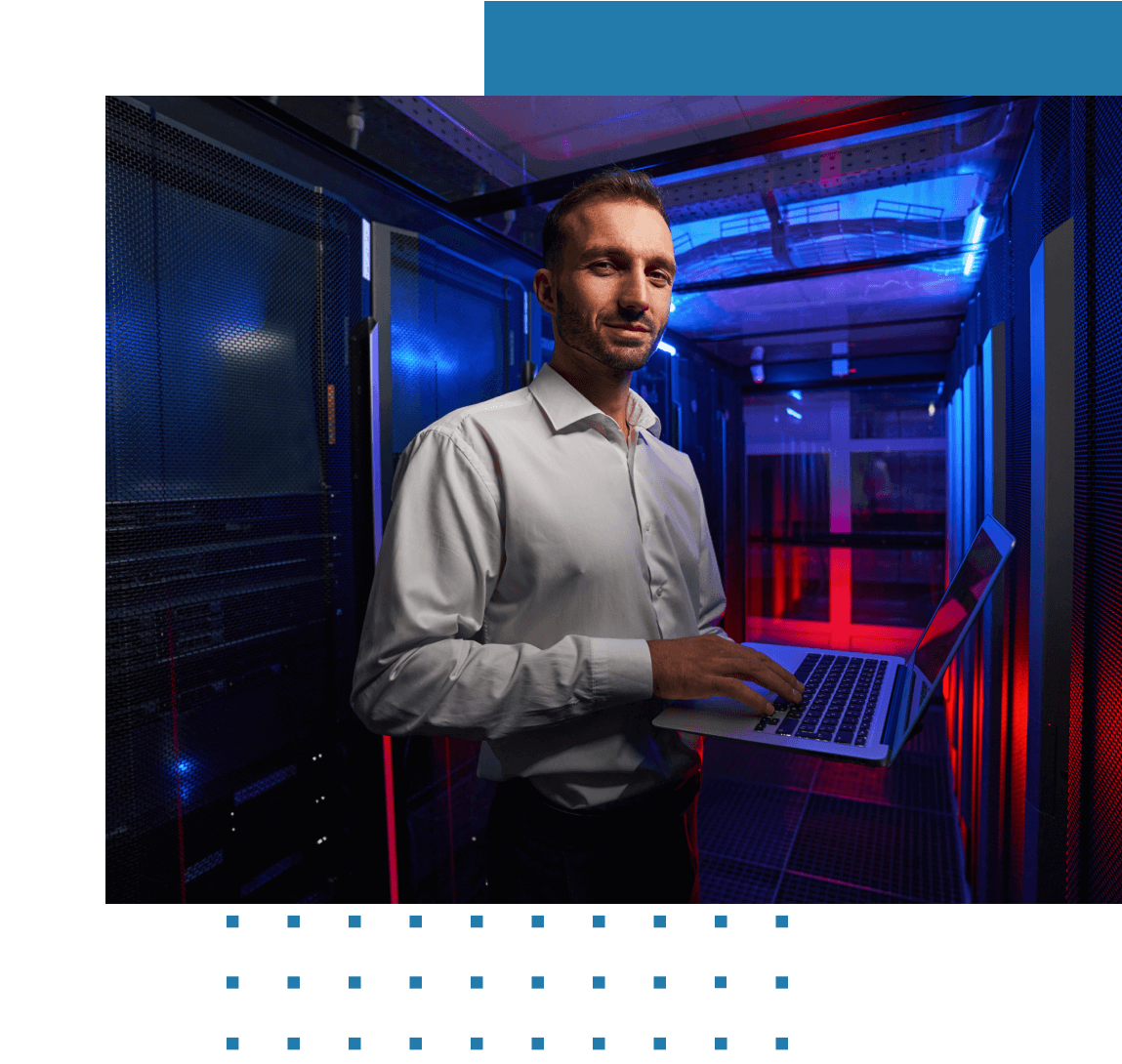 A man operates a laptop in a vCenter server room.