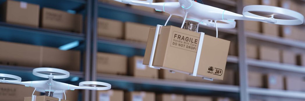 Drones fly through a central warehouse loaded with packages