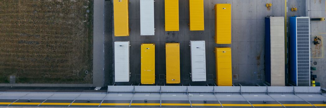 Truck trailers arranged in the row in the yard of a forwarding company.