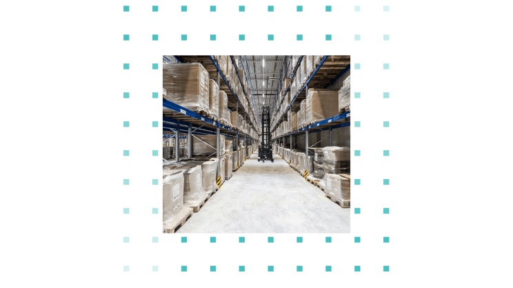 An aisle in a warehouse where a forklift truck is travelling.