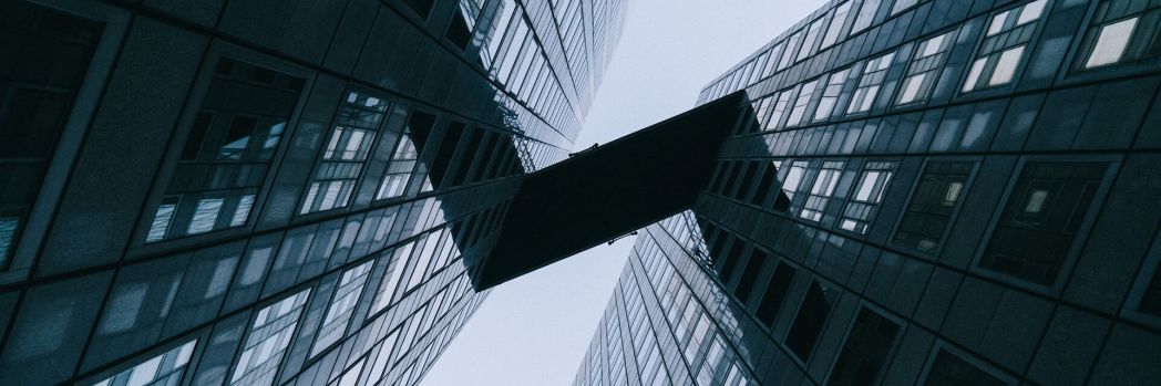 Two glass skyscrapers that are connected to each other