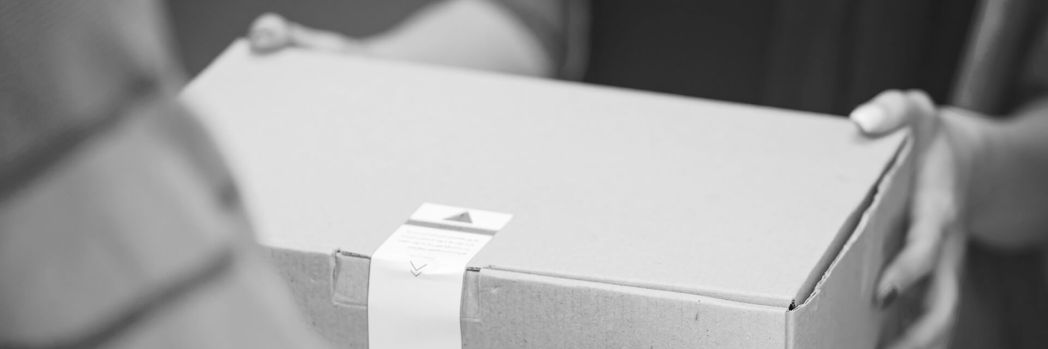 Man hands over package to a woman