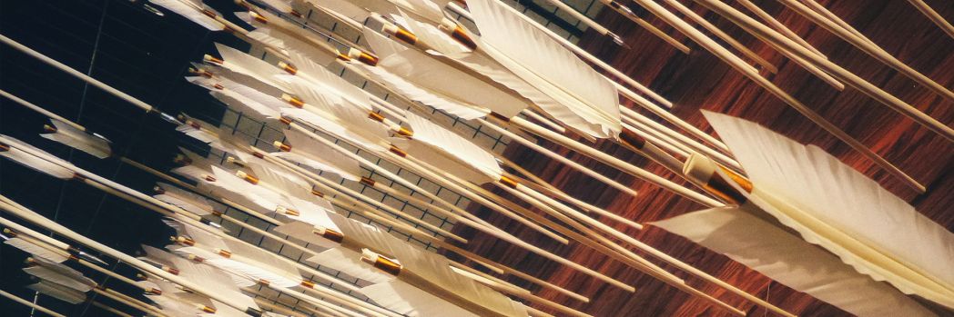 White arrows in the wall representing a network attack and the firewall.