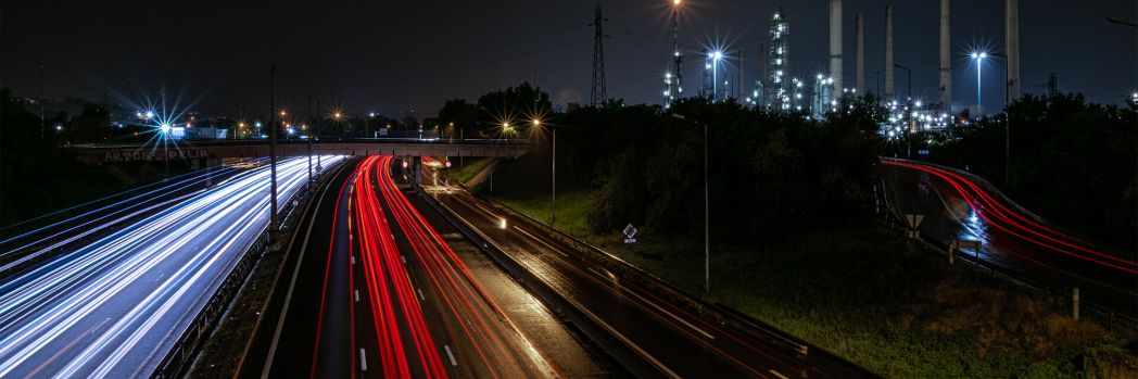 Many streams of light on a large dark highway