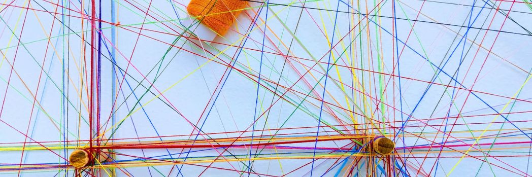 Many colorful threads, which stand for the connections within a logistics chain.