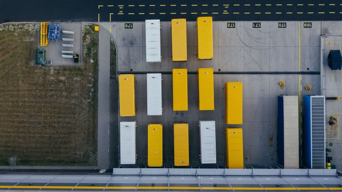 Truck trailers arranged in the row in the yard of a forwarding company.