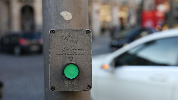 Panel with green round button and running man