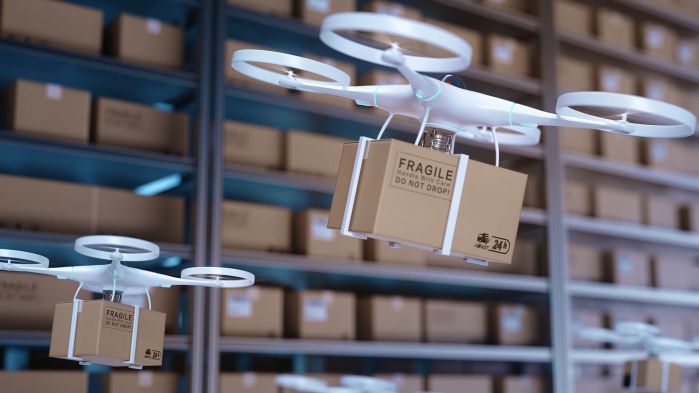 Drones fly through a central warehouse loaded with packages