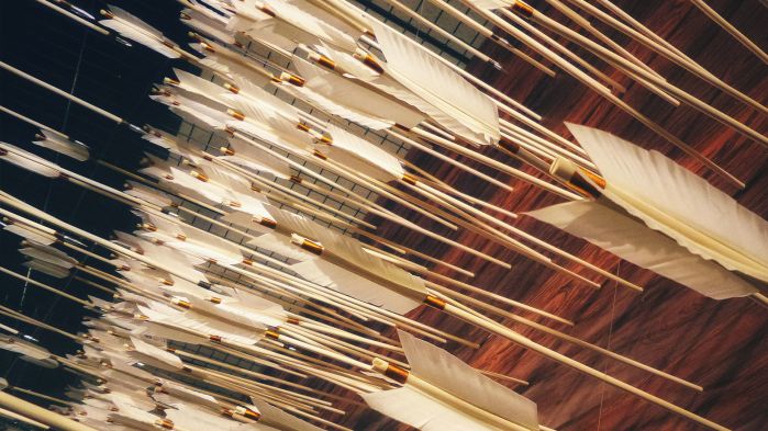 White arrows in the wall representing a network attack and the firewall.