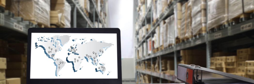 Laptop with map on the screen standing on the desk in a warehouse