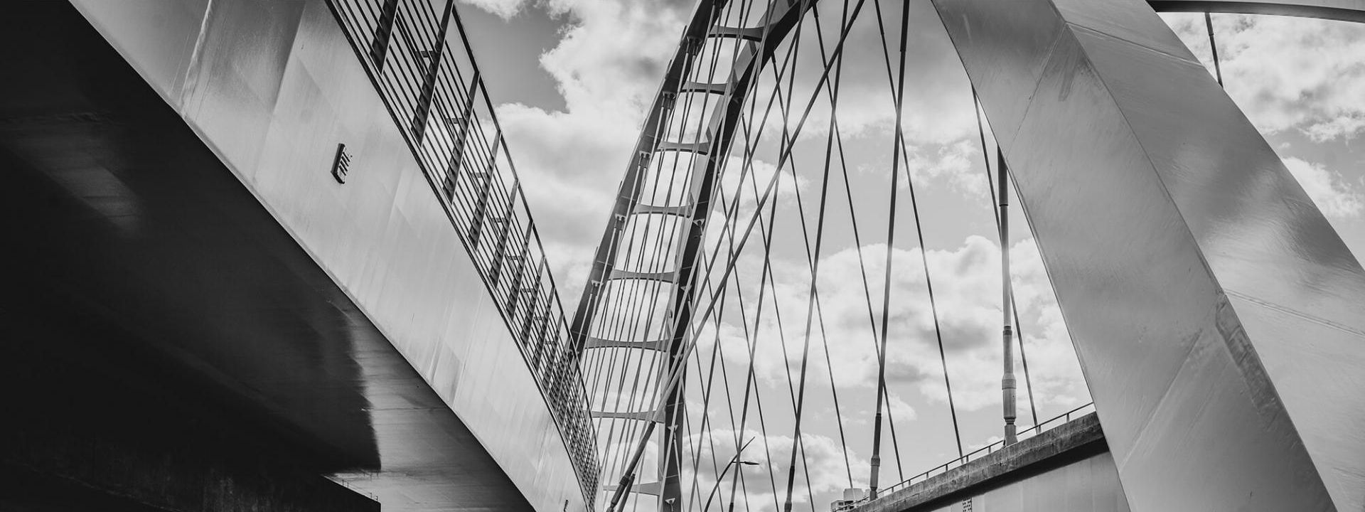 Ein schwarz-weißes Bild zeigt einen Brückenbogen.