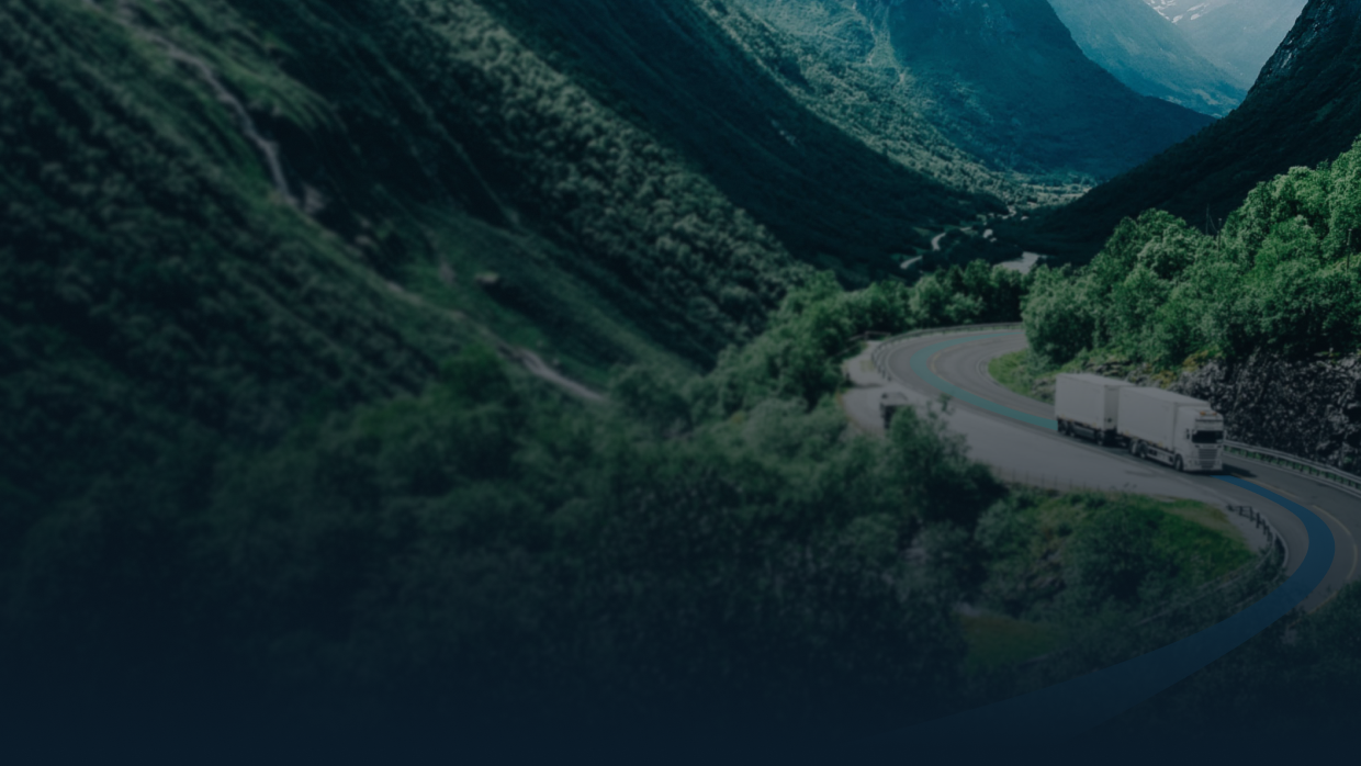 A winding mountain road on which a lorry is driving, its consignment being followed.